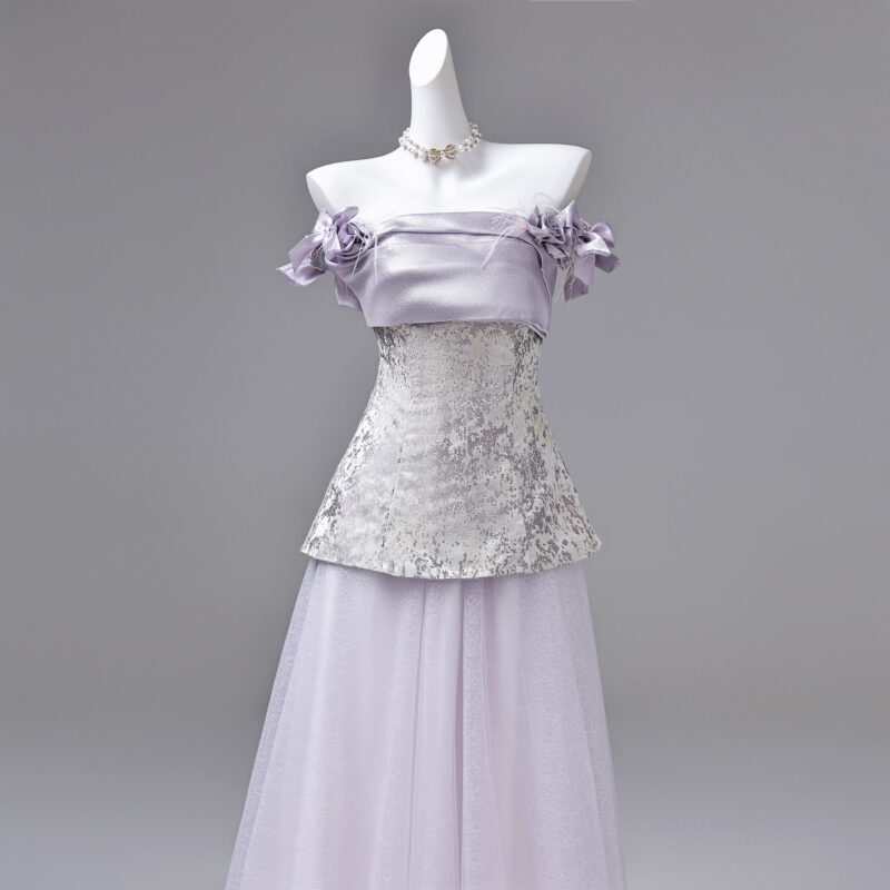 The combination of satin and tulle creates a distinctive style for the product Evening Dress